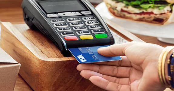 USA Today photo of a person paying with an EMV-chip card. 