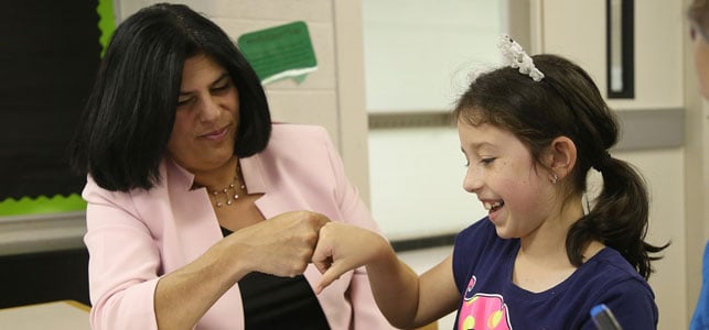 A photo of DFCU Livonia branch manager and a student