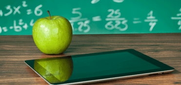 An apple on a teacher's desk