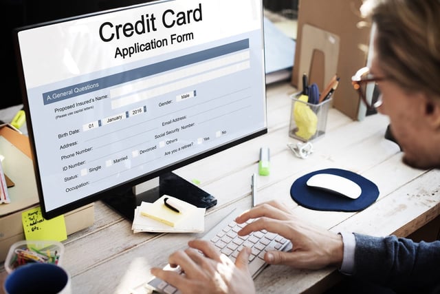 Photo of a person applying for a credit card online Photo of a person applying for a credit card online