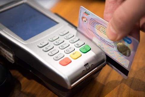 Photo of a credit card being swiped Photo of a credit card being swiped