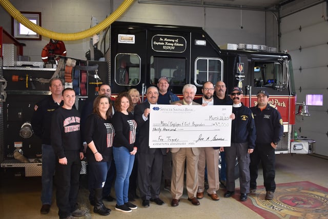 Photo of Spencer Savings Bank employees donating a check to Marcal employees and first responders