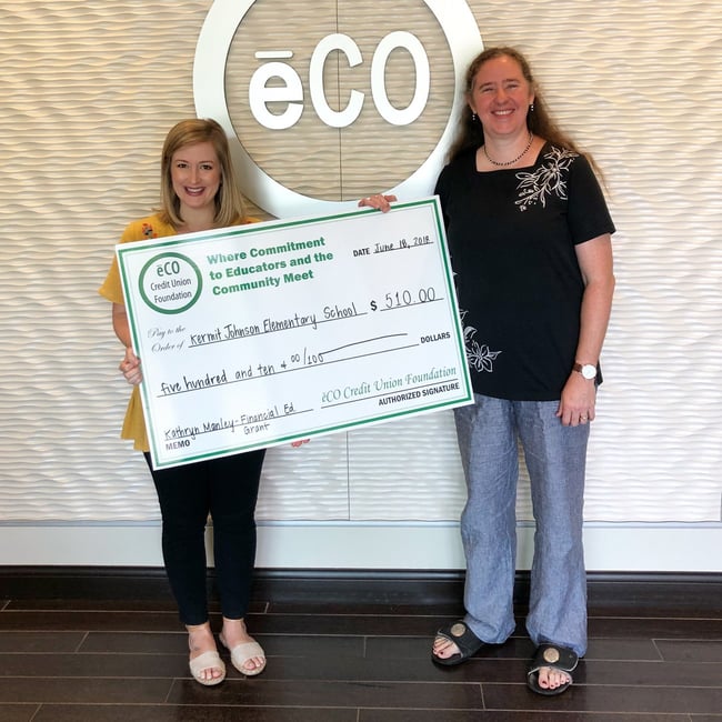 Photo of Melissa Stewart, eCOâs Marketing Director, presenting Kathryn Manley with a financial education grant.