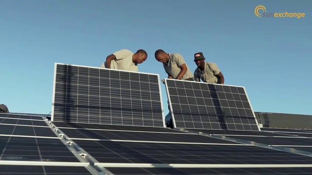 Photo of workers installing solar panels Photo of workers installing solar panels