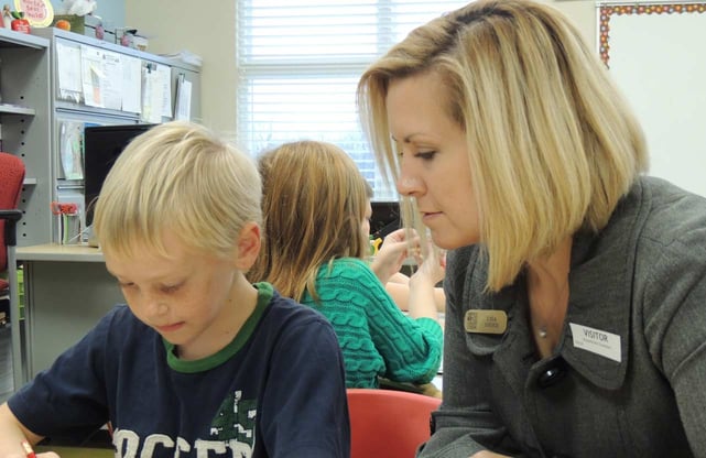 Photo of Service One Credit Union employee helping student