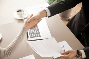 Credit Union Employee and Member Shaking Hands