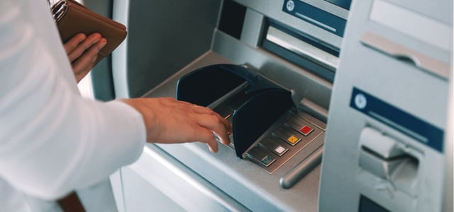 Photo of a man at an ATM Photo of a man at an ATM