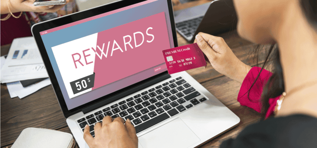 Photo of a credit card and a laptop Photo of a credit card and a laptop