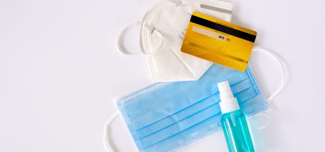Photo of a credit card, two masks, and sanitizer Photo of a credit card, two masks, and sanitizer