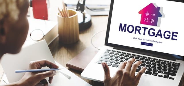 Woman applying for a mortgage online. Woman applying for a mortgage online.