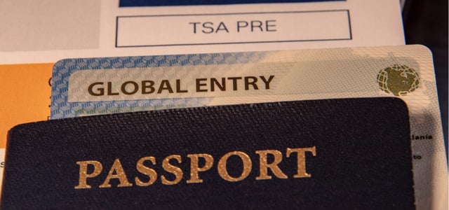 Photo of a passport, Global Entry card, and TSA Precheck paper.