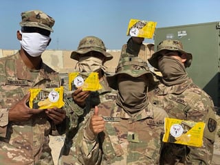 Photo of service members holding good from Soldiers' Angels