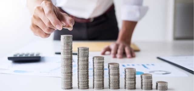 Photo of a man stacking coins.