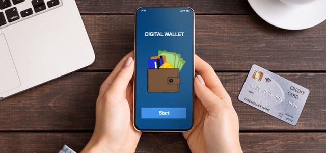 Digital Wallet on an iPhone Next to a Credit Card Digital Wallet on an iPhone Next to a Credit Card