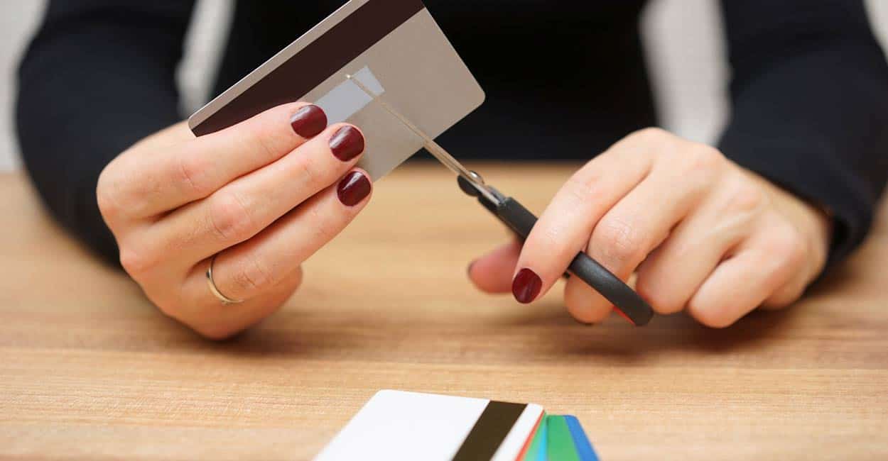 Photo of consumer cutting credit cards 