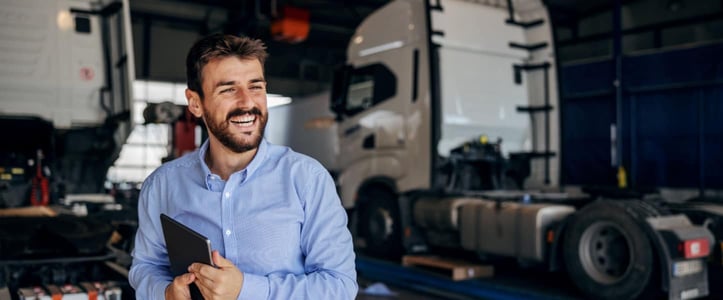 man standing in front of an 18-wheeler, business concept