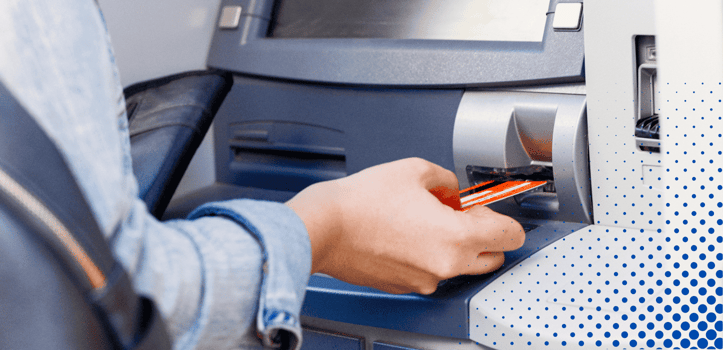 Person using a bank card at an ATM Person using a bank card at an ATM