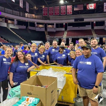 Credit union volunteers distributing school supplies in Boston Credit union volunteers distributing school supplies in Boston