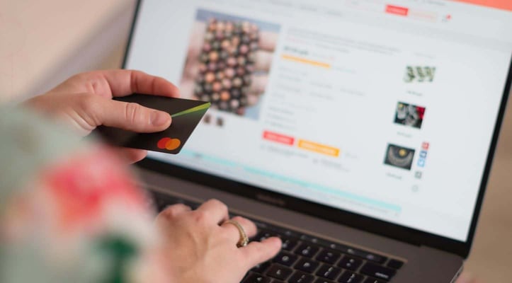 Person using a credit card to make an online purchase Person using a credit card to make an online purchase