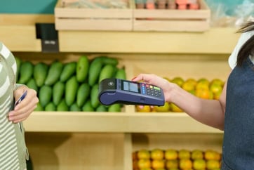 merchant terminal and card in grocery store