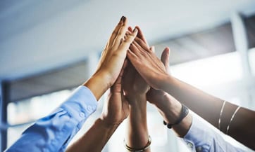 coworkers placing hands together coworkers placing hands together