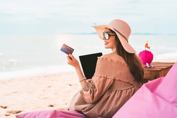 woman on beach with credit card woman on beach with credit card