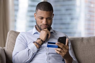 person with card and phone person with card and phone