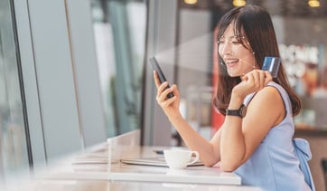 woman with card and phone woman with card and phone