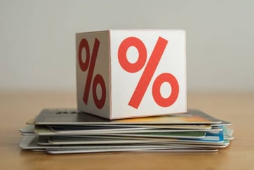 block with percent sign on stack of cards block with percent sign on stack of cards