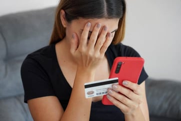 woman holding phone and card woman holding phone and card