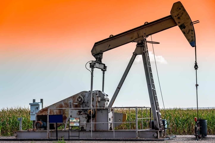 Oil pump jack with sky in background Oil pump jack with sky in background