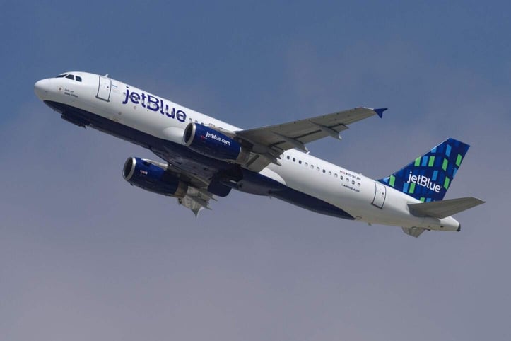 Photo of a JetBlue plane in flight Photo of a JetBlue plane in flight