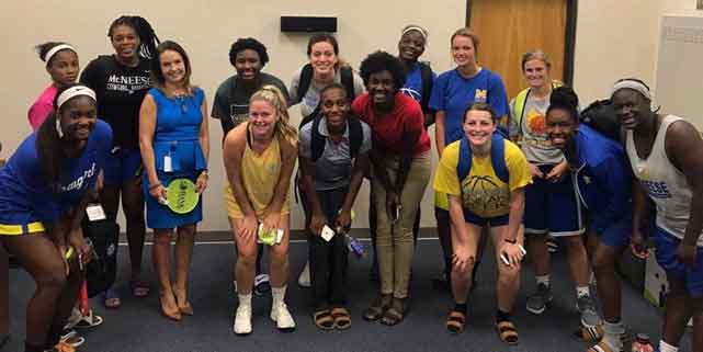 Photo of Dawn Primeaux with McNeese State women's basketball team