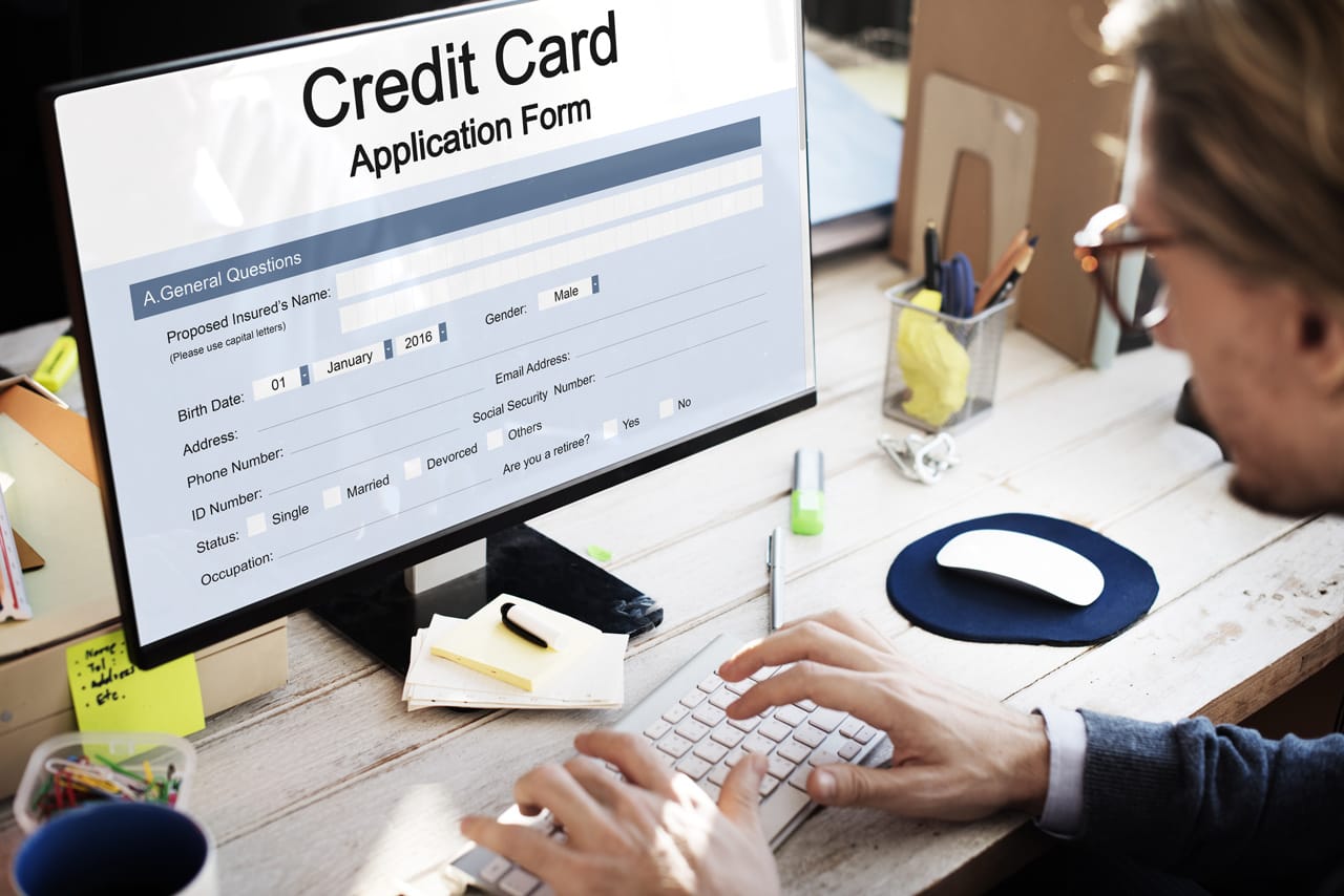 Photo of a person applying for a credit card online Photo of a person applying for a credit card online